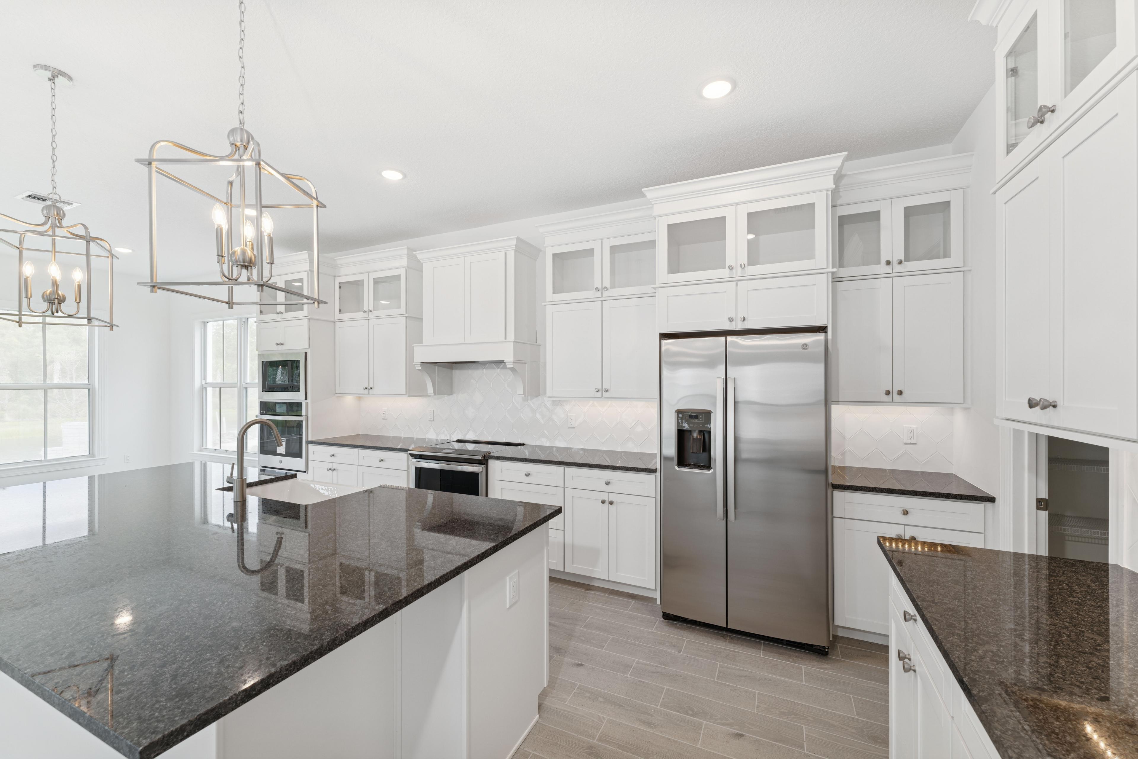 Kitchen with stacked glass-front upper cabinets