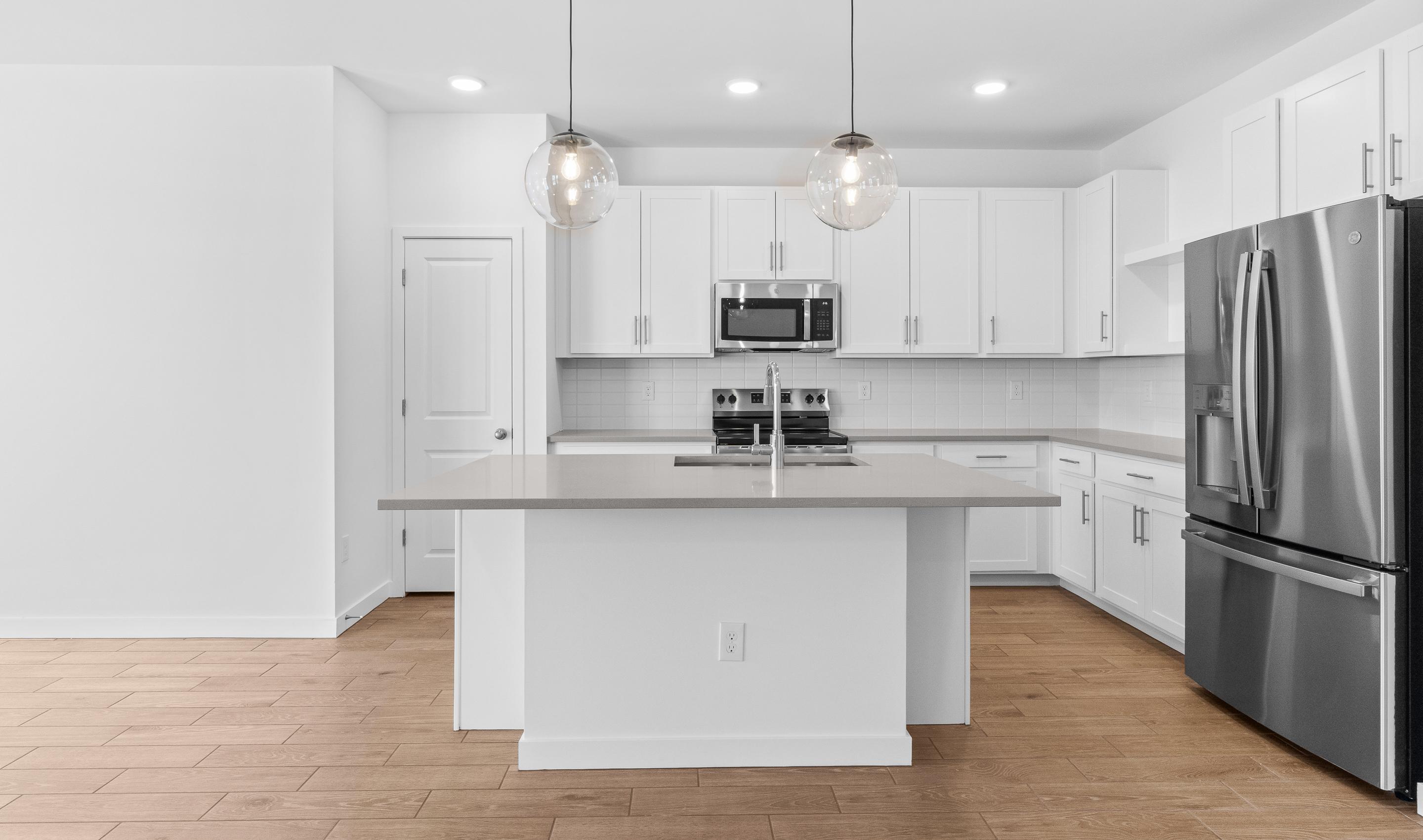 Kitchen with quartz island & pendant lights